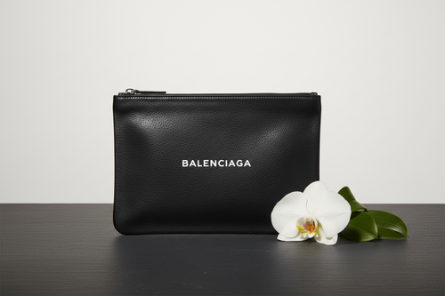 Elegant front view of Balenciaga Everyday clutch in black leather with white logo print