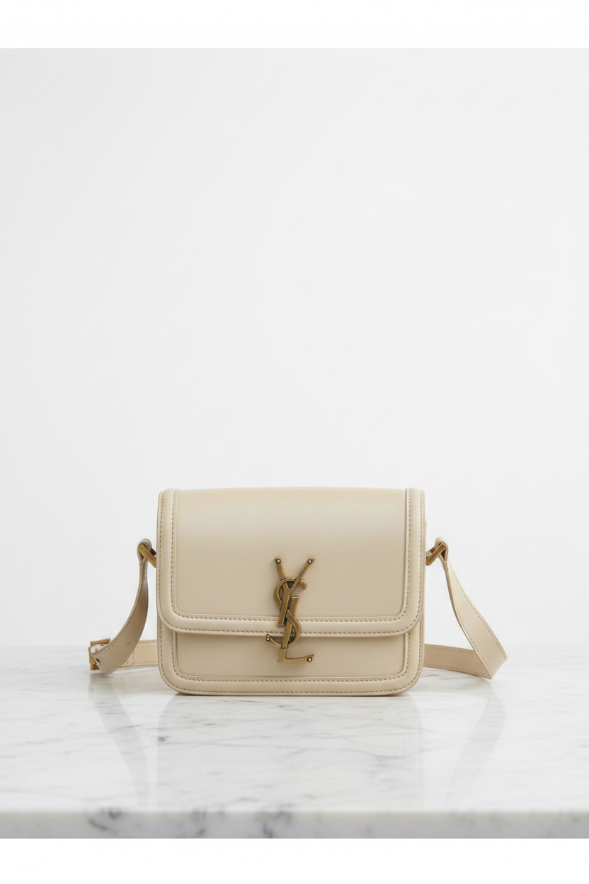 Elegant front view of Saint Laurent Solferino crossbody bag in cream leather with gold YSL monogram hardware